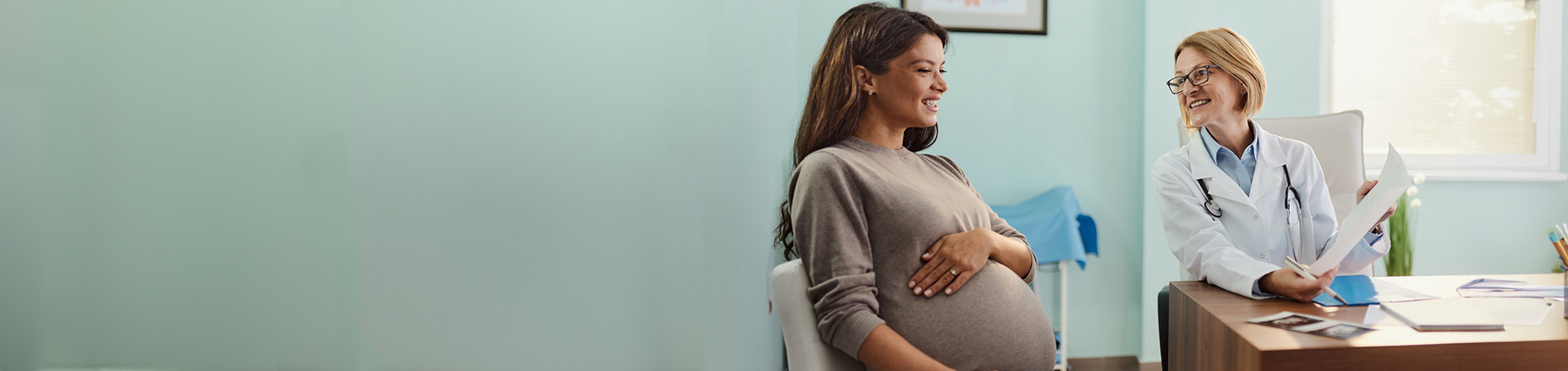Pregnant woman in doctor's office with doctor