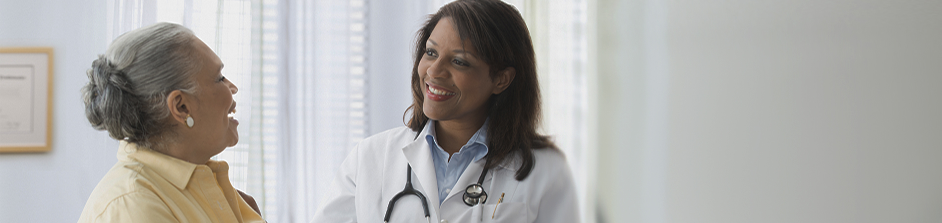 Older woman talking to doctor in office